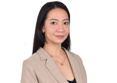 Professional headshot of a real estate virtual assistant wearing a beige blazer and gold necklace.